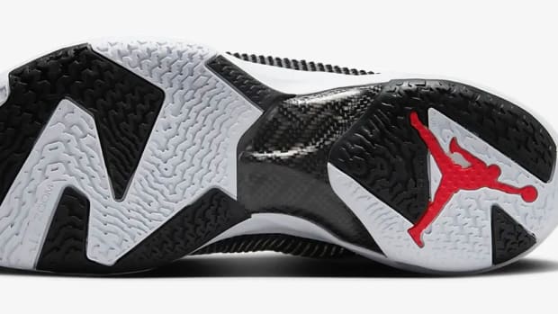 View of white, lack, and red Air Jordan shoe.